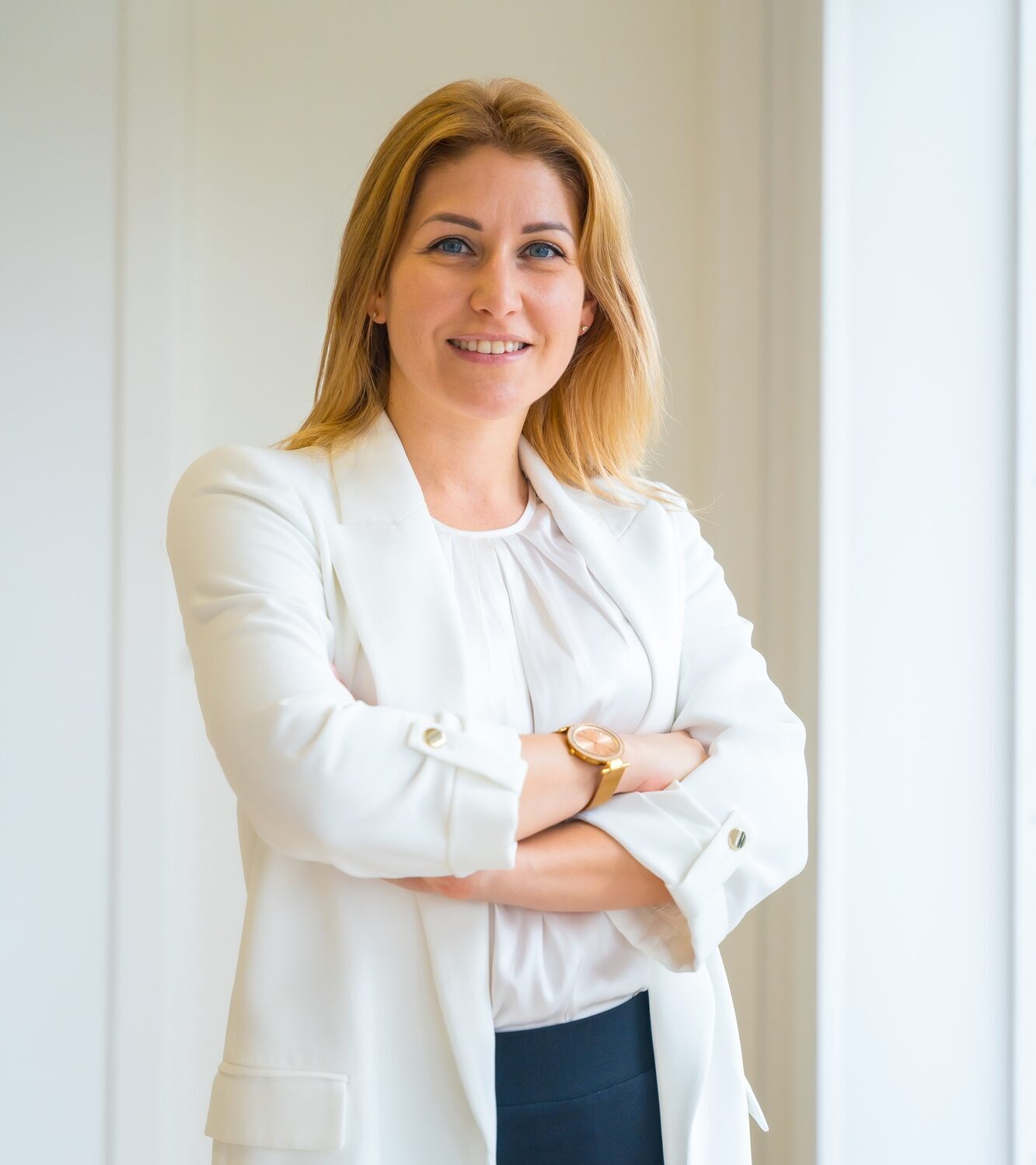 Proud estate agent standing with arms crossed in the office