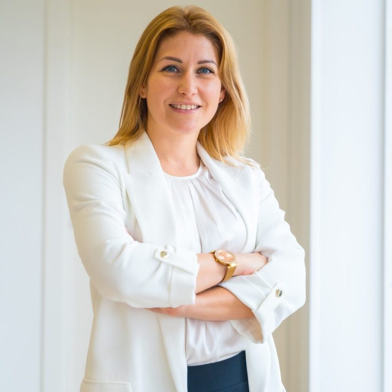Proud estate agent standing with arms crossed in the office